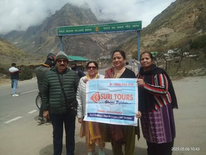 Suri Tours clients with banner at Mana Village — First Indian Village near Badrinath